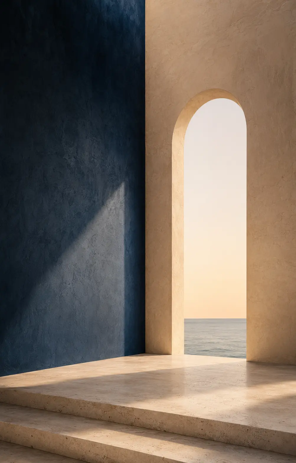 A sunlit limestone wall with a tall arched opening onto the Atlantic horizon, beside a deep blue wall in shadow.